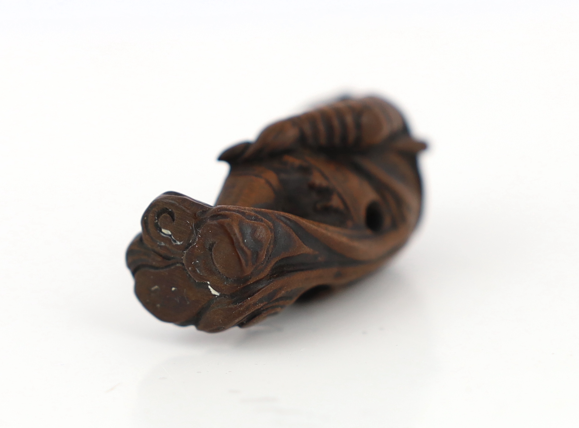 A Japanese wood netsuke of Son Goku (Sun Wukong) flying on his cloud somersault, early 19th century, signed Sentsu